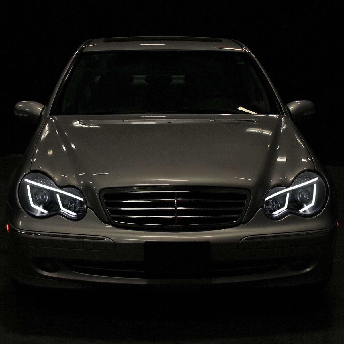 2001-2007 Mercedes Benz W203 C Class Sedan Projector Headlights w/ LED Light Bar & LED Turn Signal Lights (Matte Black Housing/Clear Lens)