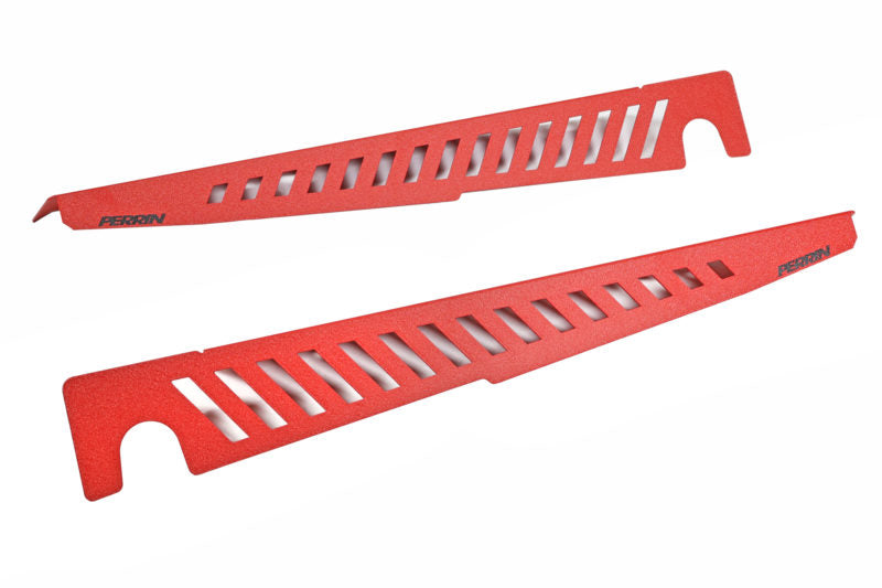 Red Fender Shrouds with cut-out designs, designed for enhanced airflow and aesthetic appeal in automotive applications.