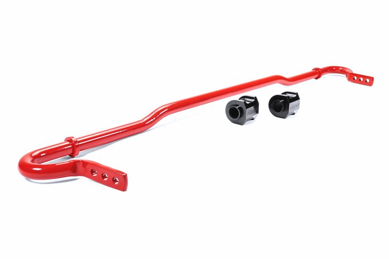 Red rear sway bar for Subaru Crosstrek, accompanied by two black bushings for installation.
