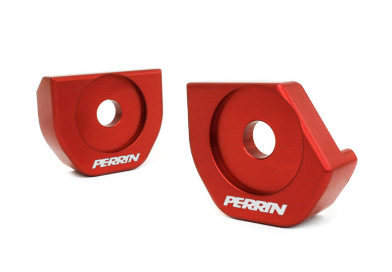 Red aluminum steering rack lockdown brackets for BRZ, FR-S, 86, and GR86, featuring the Perrin logo.