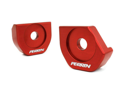 Red aluminum steering rack lockdown brackets for BRZ, FR-S, 86, and GR86, featuring the Perrin logo.