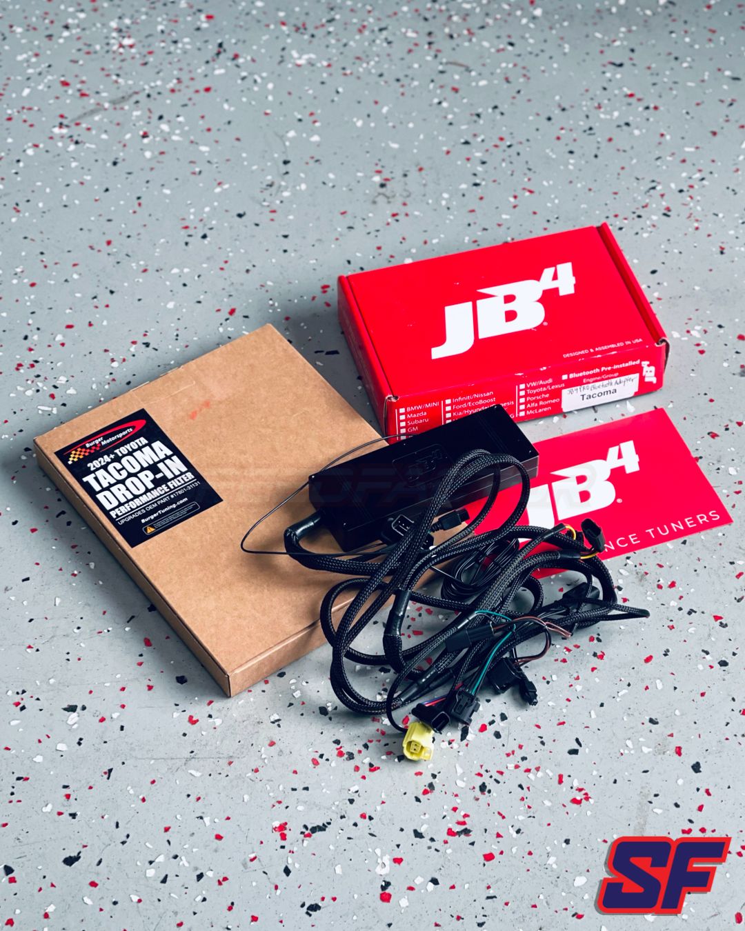 JB4 product packaging with wiring harness on a speckled gray surface