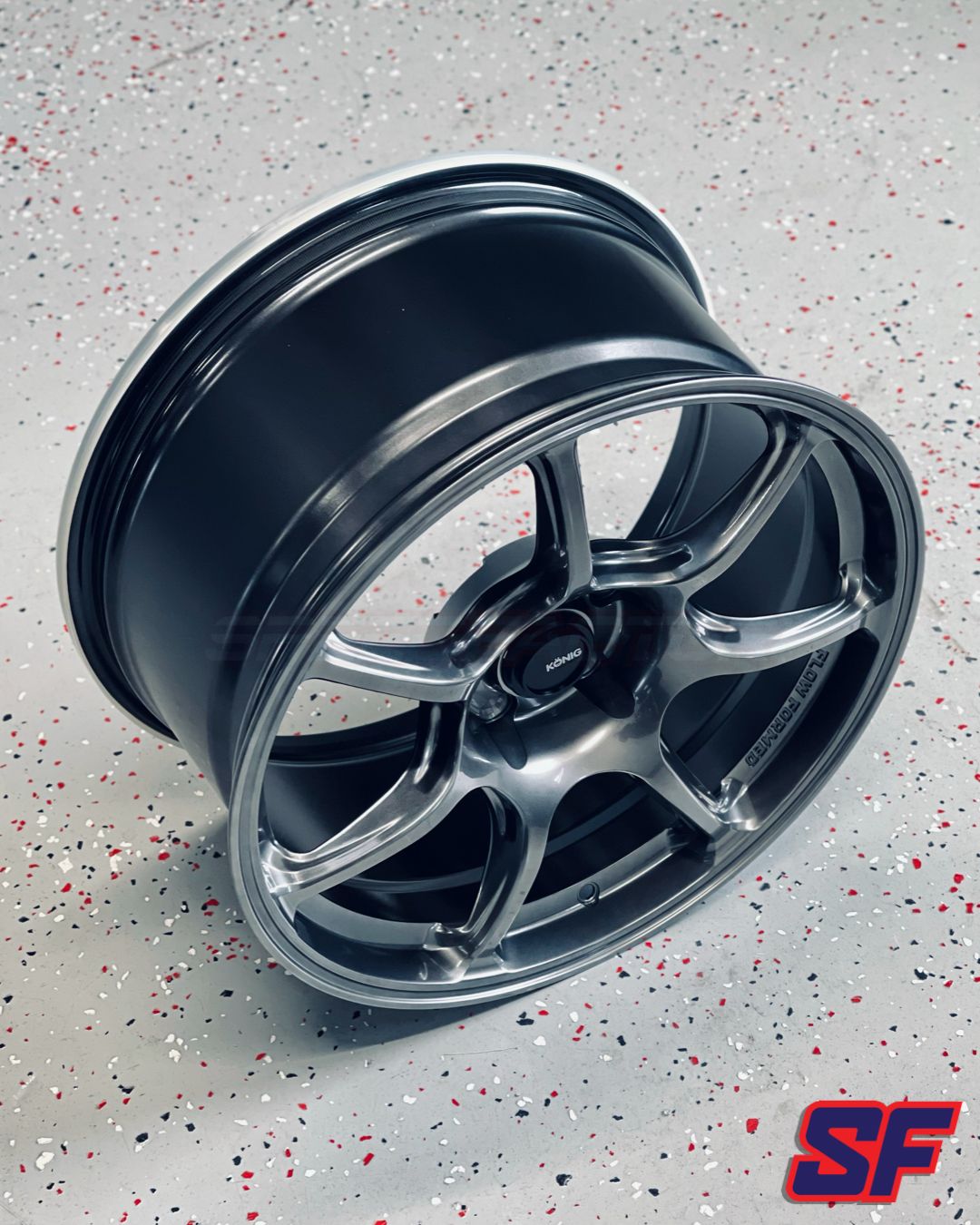 Car wheel rim on a speckled gray background with 'SF' logo.