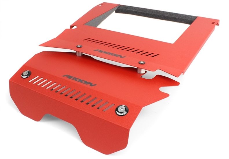 Red intercooler shroud with ventilation slots and mounting hardware, designed for improved airflow and engine performance.
